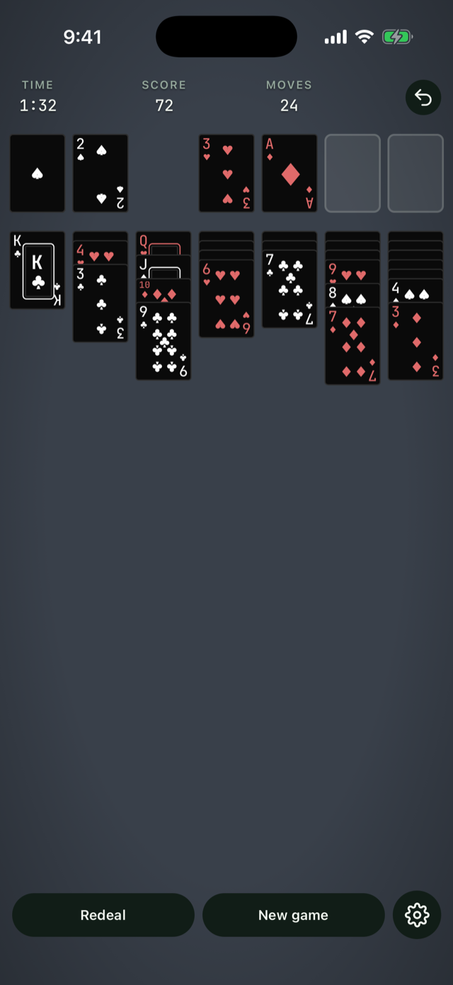 An early game with the Modern deck on the slate table, first aces on the foundations